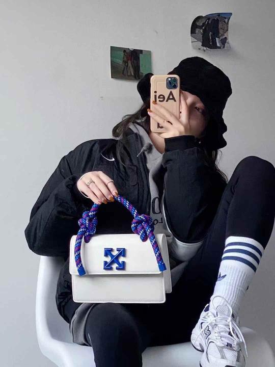 Off White Leather Insert Gummy white with Metallic Blue Arrows At Front. Rope Handle Jitney 1.4 Shoulder Bag (D88532 White)