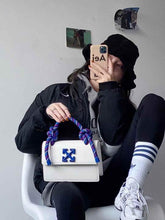 Off White Leather Insert Gummy white with Metallic Blue Arrows At Front. Rope Handle Jitney 1.4 Shoulder Bag (D88532 White)